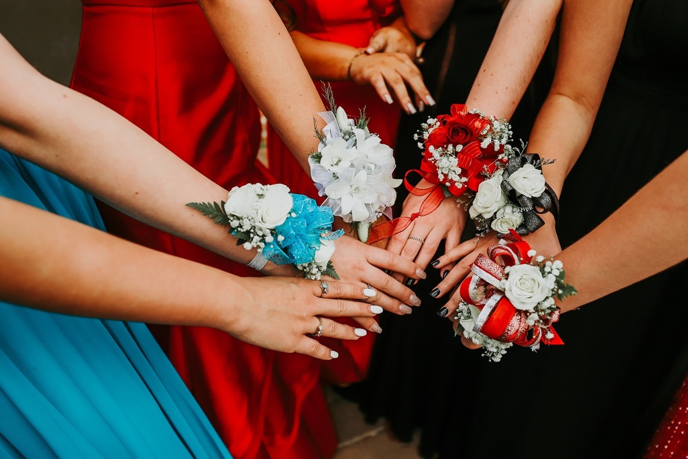 Hands in a circle with corsages