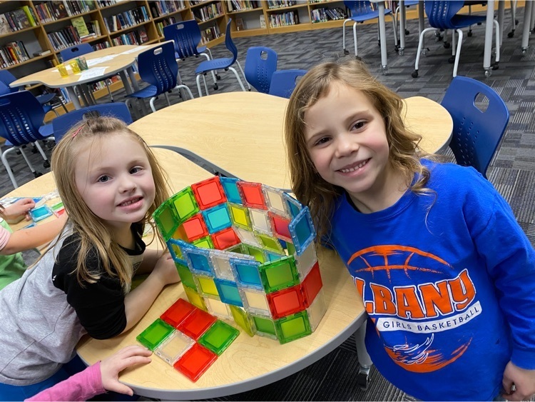 two students building with magnetic blocks